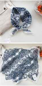 Close-up of bohemian blue floral cotton linen scarf with paisley patterns and soft texture