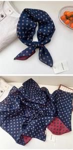 Close-up of lightweight navy blue and dark red polka dot silk scarf with flat edges