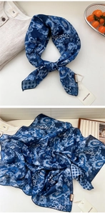Detail of navy blue paisley cotton linen scarf with fine stitched edges and tag