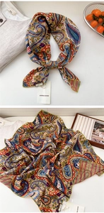 Detail of yellow paisley cotton linen scarf with green stitching and brand tag