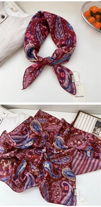 Close-up of wine red paisley cotton linen scarf with tag showing fabric and print details