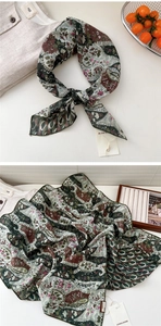 Detail view of cotton-linen neckerchief featuring vintage paisley pattern and rolled edges