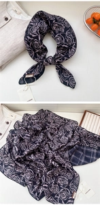 Detail of double-sided cotton-linen scarf with floral print and classic navy plaid patterns