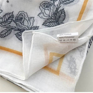 Detailed close-up of floral cotton-linen scarf with 35% cotton material and wash label