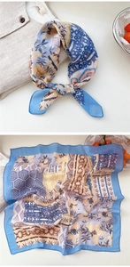 Detailed macro view of bohemian floral cotton linen scarf with blue border and vintage pattern