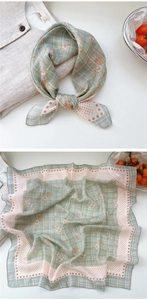 Detailed flat lay of floral cotton linen square scarf with green plaid and pink dot border