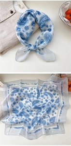 Detail of blue and white paisley cotton linen scarf with soft translucent fabric texture