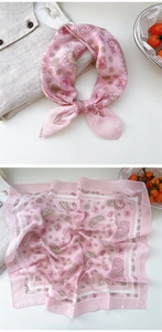 Detail shot of pink linen silk scarf featuring classic paisley patterns and elegant knot design