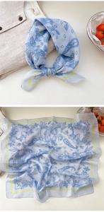 Close-up of floral cotton linen neck scarf with blue paisley patterns and yellow border