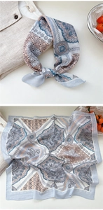Detailed macro view of paisley and geometric patterns on a soft cotton linen floral scarf