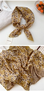 Détail de foulard en soie vintage à motif paisley jaune gingembre avec ourlet fin