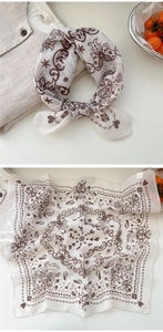 Detail of soft beige cotton linen square scarf with brown coffee paisley print and knot