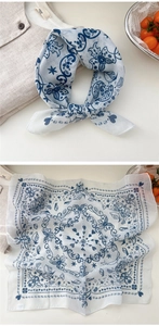 Detailed view of linen neckerchief with blue paisley pattern and decorative knot