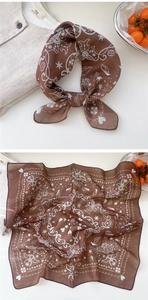 Detail view of dark brown linen-cotton neck scarf with white coffee theme patterns