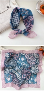 Detailed macro view of retro pink and blue batik floral print on soft cotton linen scarf