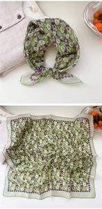 Detail showing floral cotton linen scarf with soft pastel flowers and purple geometric border