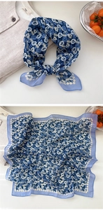 Detail of blue floral cotton linen square scarf with delicate rose patterns and soft texture