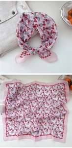 Detail view of pink floral cotton linen neck scarf with delicate wavy red border edges