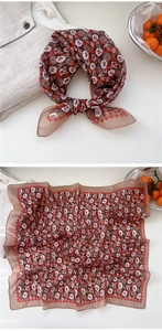 Close-up of retro floral cotton-linen scarf with red wavy edges and rustic French pattern