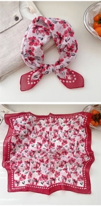 Detail of red floral cotton linen scarf with geometric border on a white linen shirt