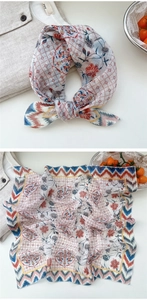 Close-up detail of a vintage floral cotton linen scarf used as a decorative necktie