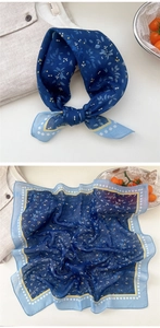 Close-up of blue floral cotton linen scarf with elegant leaf and berry print details