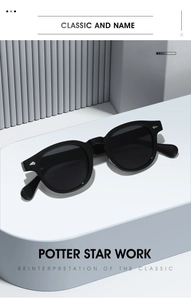 Détail de lunettes de soleil ovales avec rivets en diamant argenté sur monture noire