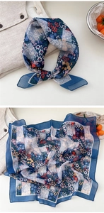 Detailed close-up of dark blue floral cotton linen scarf with breathable texture