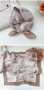 Detail of vintage floral cotton linen scarf with geometric pattern and red border