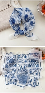 Detail view showing blue paisley floral patterns on a lightweight square cotton scarf