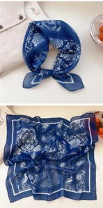 Detail of navy blue cotton linen scarf featuring white peacock paisley print patterns