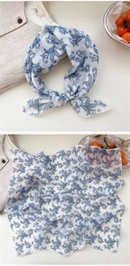 Close-up of floral cotton linen scarf with vintage blue botanical patterns on white