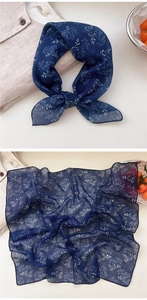 Detail of navy blue floral cotton linen scarf showing delicate white dandelion patterns