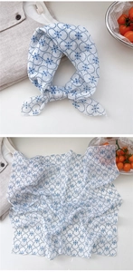 Detailed view of lightweight blue floral cotton linen scarf with breathable semi-sheer fabric