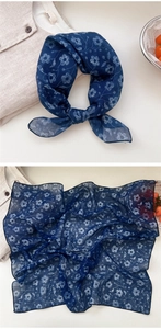 Detail of navy blue floral cotton linen scarf featuring delicate white small blossom patterns