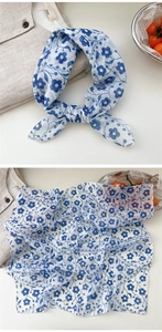 Detailed view of blue floral cotton linen scarf with breathable fiber texture and pattern