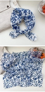 Detail of blue and white floral cotton linen scarf with soft texture and pattern view