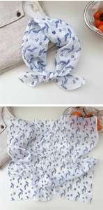 Close-up of cotton linen floral scarf with blue botanical prints and soft texture