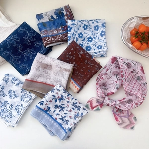Flat lay of vintage floral cotton linen neck scarves in diverse patterns and colors
