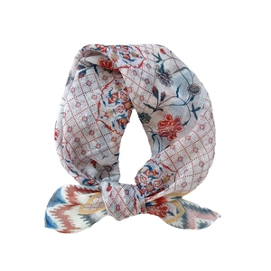 Floral cotton linen scarf with vintage patterns in red and gold on a white backdrop