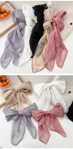 Detailed view of light chiffon hair scarves in lilac, cream, black, apricot, and dusty pink