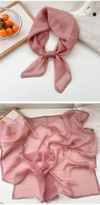 Detail view of dusty rose silk scarf with fine lock-stitch edges and lightweight texture