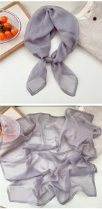 Detail of light purple sheer scarf showing delicate edge stitching and draped texture