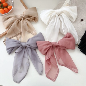Set of four sheer chiffon hair bows in pastel colors with delicate lace embroidery