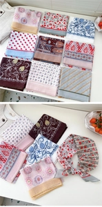 Macro detail of various vintage floral and geometric pattern scarves for neck or hair