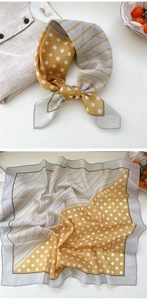 Detailed view of floral silk square scarf with yellow polka dots and grey striped patterns