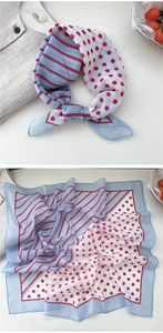 Detail of light blue floral square scarf with red polka dots and striped pattern design