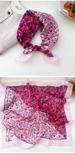 Macro detail of purple floral silk scarf featuring elegant berry prints and folded texture