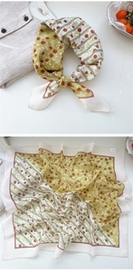 Floral square scarf detail with olive berry print and elegant bow tie styling