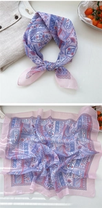 Detail of pink floral paisley scarf with bohemian pattern and lightweight texture